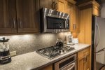 Fully equipped kitchen has stainless steel appliances and granite counters 